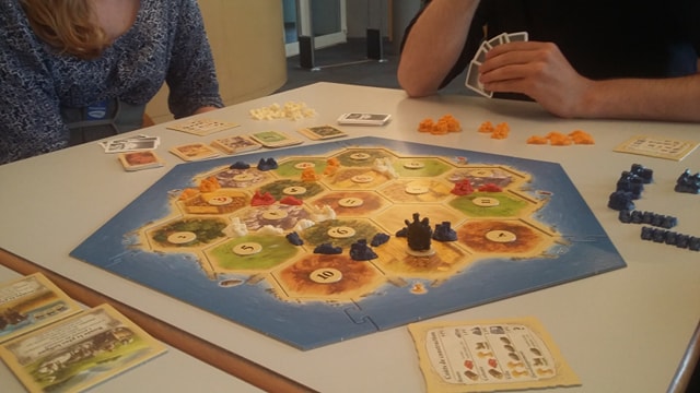 Photo of a Catan gameboard, mid-play.